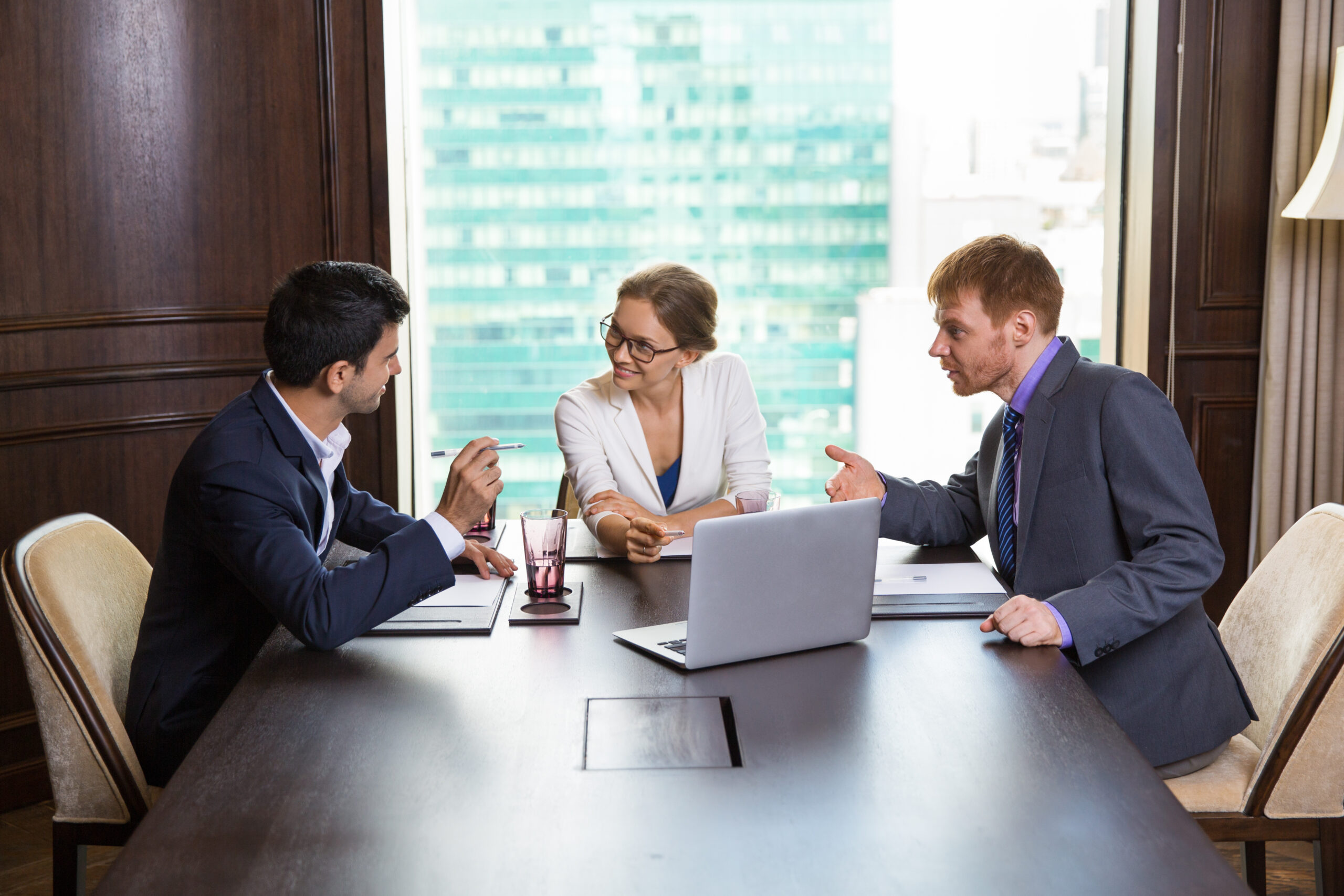 business woman talking with two businessmen